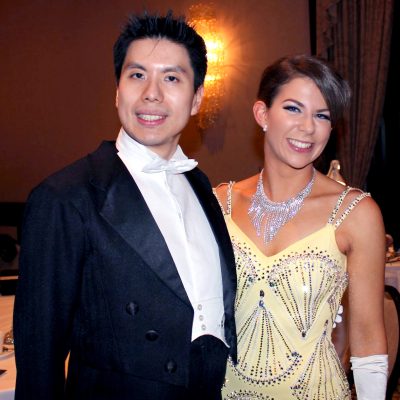 Young couple smiling at camera during a debutante ball
